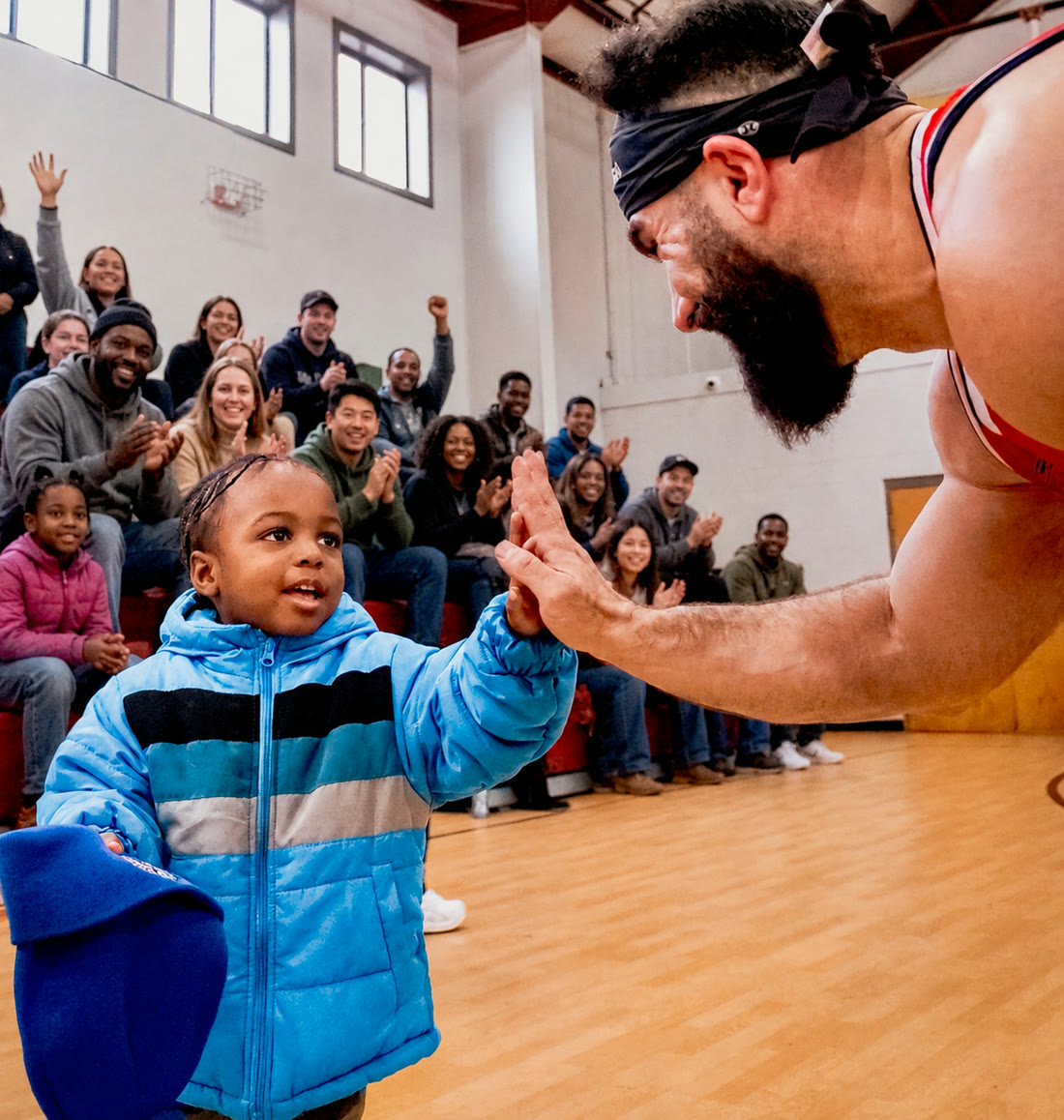 Matthew Laken high-fiving a child at a community event